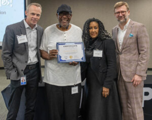 CHAN Founder CJ Page receives a certificate of achievement for completing the Collaborative Capacity Building Grant.