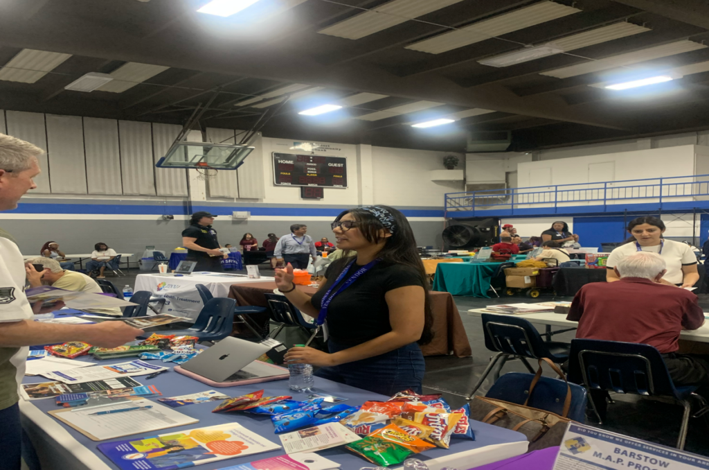 CHAN team member sharing information about cooling center and other health resources at a local health fair. 